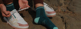 Pair of athletic sports socks with bold stripes and cushioned sole.